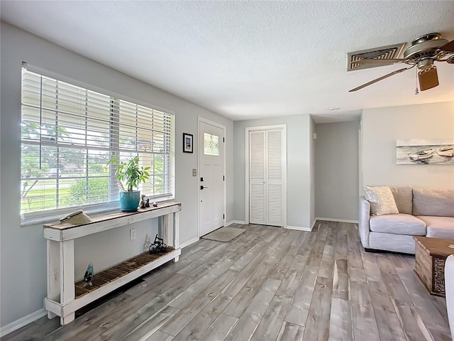 408 67th Ave W, Bradenton, FL 34207 - entrance foyer featuring healthy amount of natural light, wood finished floors, ceiling fan, and a textured ceiling