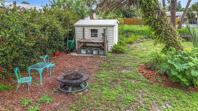 408 67th Ave W, Bradenton, FL 34207 - view of yard featuring an outdoor fire pit and a storage unit