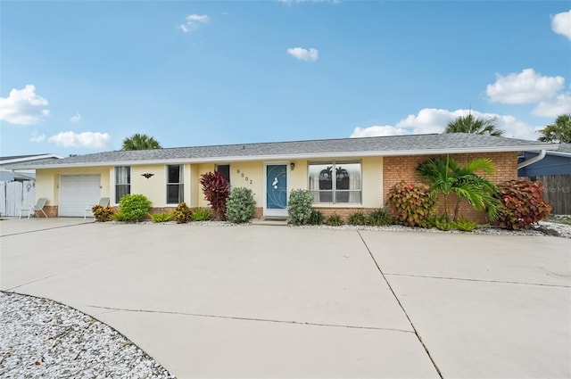 6002 34th Ave W, Bradenton, FL 34209 - ranch-style house with brick siding, driveway, an attached garage, and stucco siding