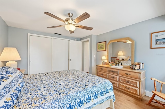 6002 34th Ave W, Bradenton, FL 34209 - bedroom with light wood-style flooring, a closet, and ceiling fan