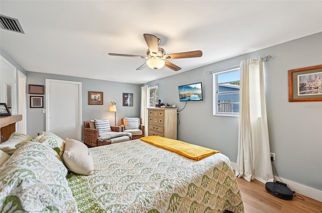 6002 34th Ave W, Bradenton, FL 34209 - bedroom with multiple windows, light wood-style floors, and a ceiling fan