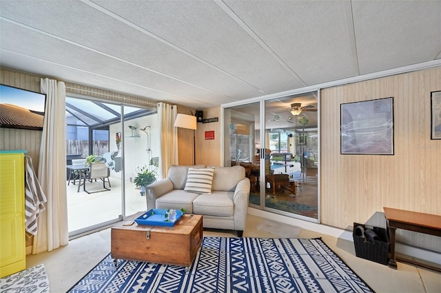 6002 34th Ave W, Bradenton, FL 34209 - living area featuring wooden walls, concrete floors, ceiling fan, and a textured ceiling