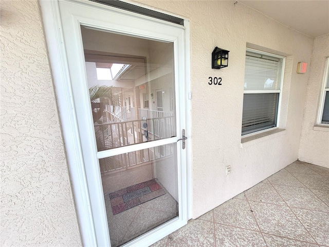 6507 Stone River Rd Unit 302, Bradenton, FL 34203 - view of exterior entry featuring stucco siding