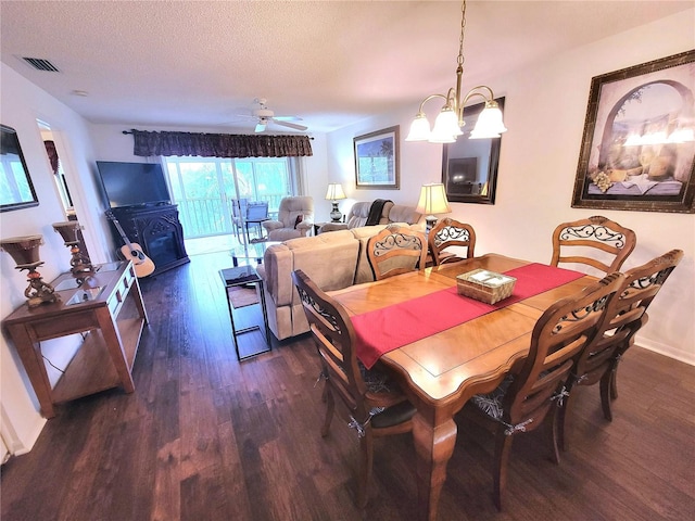 6507 Stone River Rd Unit 302, Bradenton, FL 34203 - dining space featuring wood finished floors, a chandelier, a textured ceiling, and a ceiling fan
