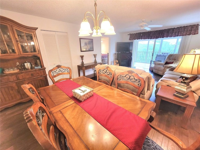 6507 Stone River Rd Unit 302, Bradenton, FL 34203 - dining area featuring a chandelier, wood finished floors, ceiling fan, and a textured ceiling