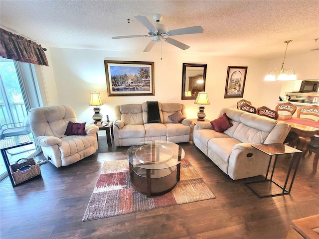 6507 Stone River Rd Unit 302, Bradenton, FL 34203 - living room featuring a textured ceiling, wood finished floors, ceiling fan, and a chandelier