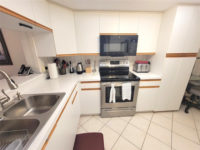 6507 Stone River Rd Unit 302, Bradenton, FL 34203 - kitchen featuring black microwave, stainless steel range with electric stovetop, light countertops, and white cabinetry