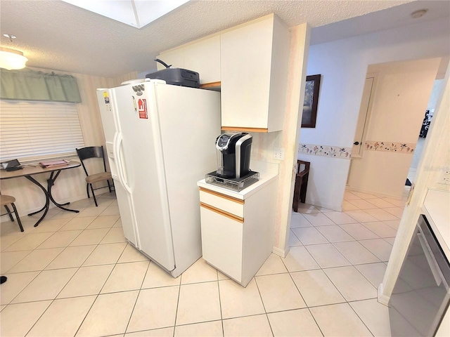 6507 Stone River Rd Unit 302, Bradenton, FL 34203 - kitchen featuring white fridge with ice dispenser, light tile patterned floors, a textured ceiling, and light countertops