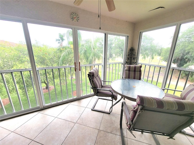 6507 Stone River Rd Unit 302, Bradenton, FL 34203 - sunroom with ceiling fan and outdoor dining space