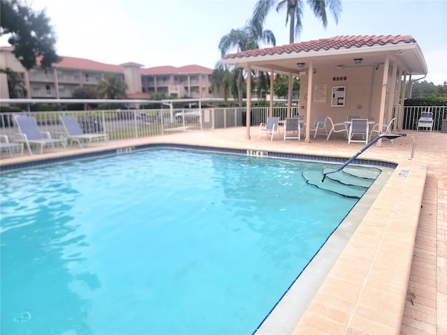 6507 Stone River Rd Unit 302, Bradenton, FL 34203 - community pool featuring a patio