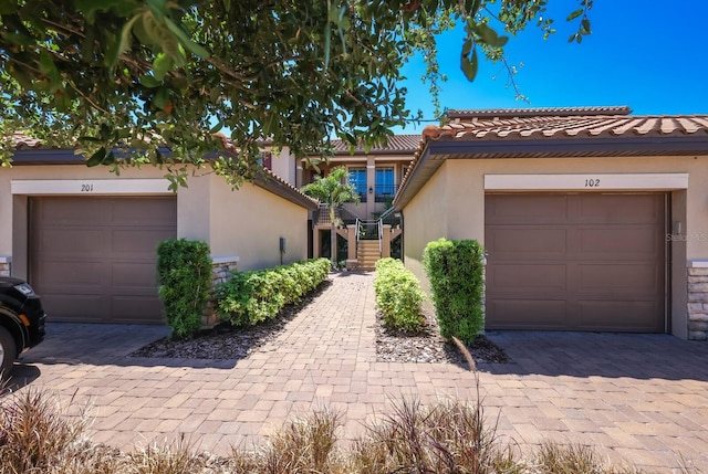 13714 Messina Loop Unit 202, Bradenton, FL 34211 - view of front of house with stucco siding, stairway, and a tile roof