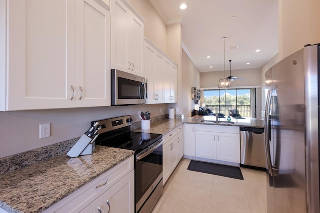 13714 Messina Loop Unit 202, Bradenton, FL 34211 - kitchen featuring appliances with stainless steel finishes, white cabinets, crown molding, light tile patterned flooring, and ceiling fan