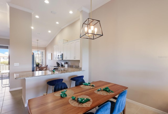 13714 Messina Loop Unit 202, Bradenton, FL 34211 - dining space with a chandelier, crown molding, light tile patterned floors, recessed lighting, and high vaulted ceiling