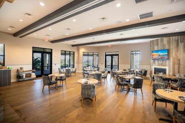 13714 Messina Loop Unit 202, Bradenton, FL 34211 - dining room with beam ceiling, wood finished floors, french doors, recessed lighting, and a fireplace