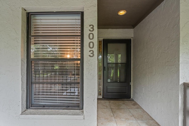 3003 Quail Holw Unit 10, Sarasota, FL 34235 - doorway to property with stucco siding