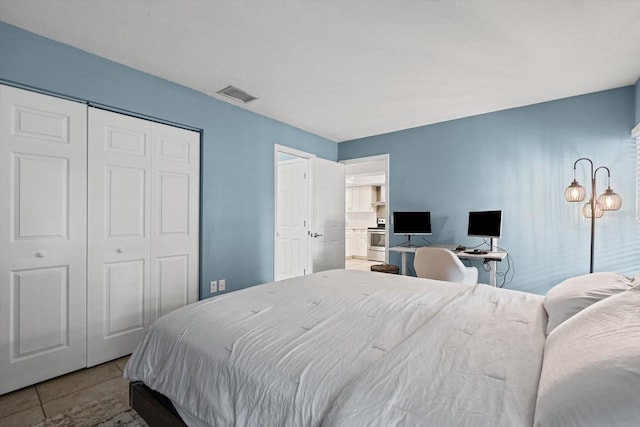 3003 Quail Holw Unit 10, Sarasota, FL 34235 - bedroom with a closet, tile patterned flooring, and a desk