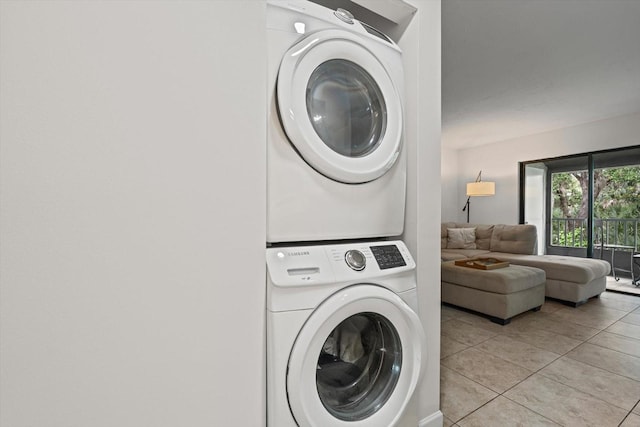 3003 Quail Holw Unit 10, Sarasota, FL 34235 - laundry area with stacked washer / drying machine and light tile patterned floors
