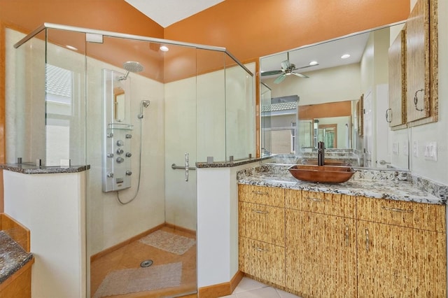 7005 Goldrush Ln, Bradenton, FL 34201 - bathroom with a ceiling fan, vanity, a stall shower, and tile patterned floors