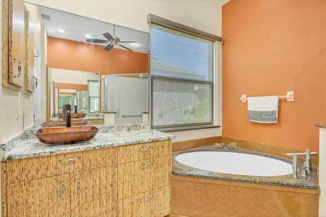 7005 Goldrush Ln, Bradenton, FL 34201 - bathroom with ceiling fan, vanity, a bath, and a stall shower