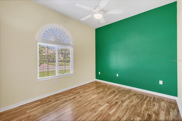 7005 Goldrush Ln, Bradenton, FL 34201 - empty room featuring wood finished floors, ceiling fan, and an accent wall