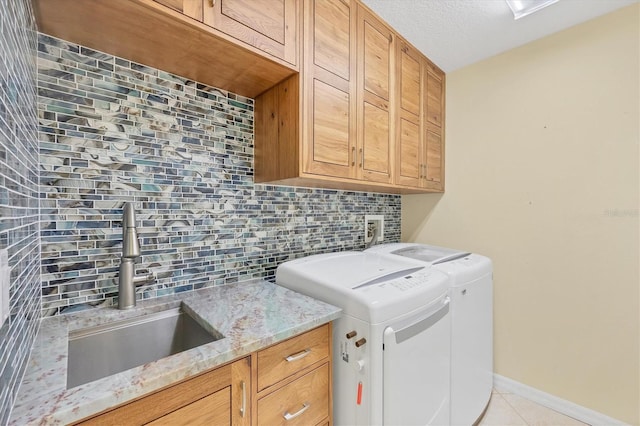 7005 Goldrush Ln, Bradenton, FL 34201 - washroom with cabinet space, light tile patterned floors, and washer and dryer