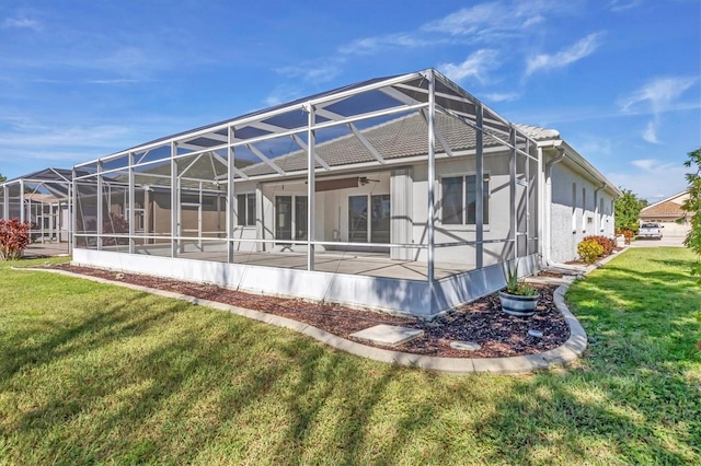 7005 Goldrush Ln, Bradenton, FL 34201 - back of property featuring a lawn, a lanai, and stucco siding