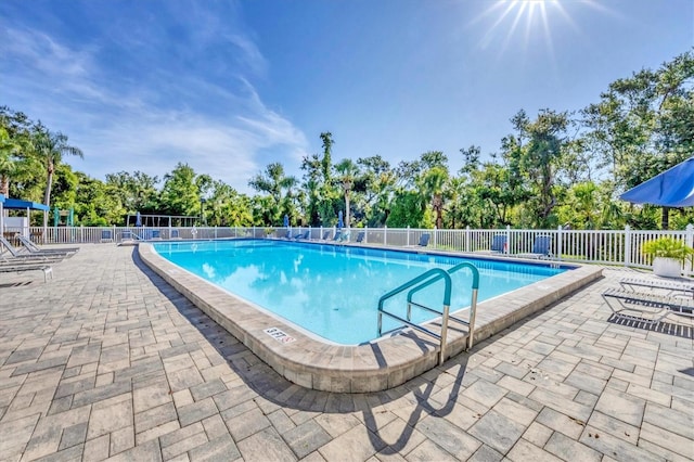 7005 Goldrush Ln, Bradenton, FL 34201 - community pool with a patio area and view of wooded area