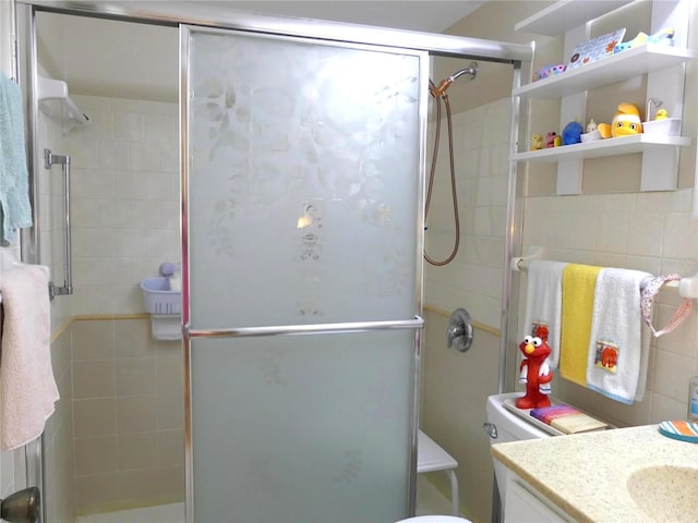1850 Sunny Dr Unit F4, Bradenton, FL 34207 - full bathroom featuring vanity, a shower stall, and tile walls