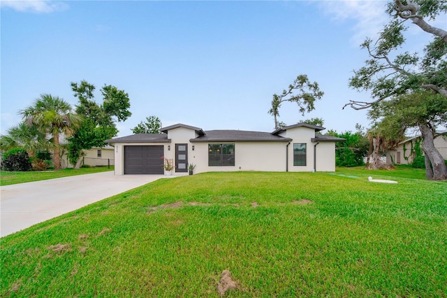 326 Randolph Rd, Venice, FL 34293 - view of front facade featuring concrete driveway, an attached garage, stucco siding, and a front lawn