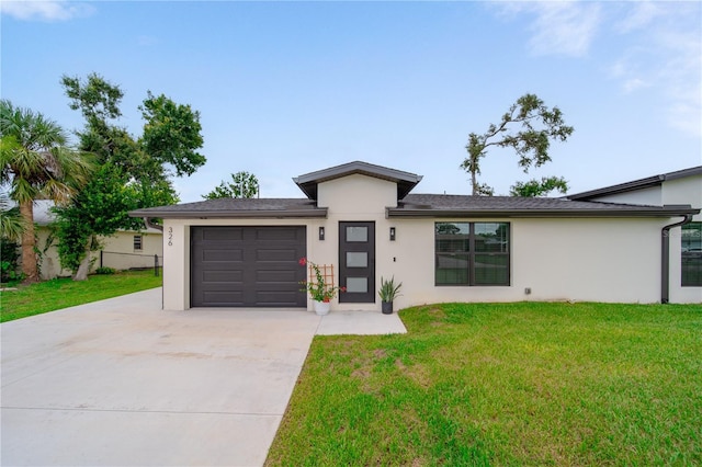 326 Randolph Rd, Venice, FL 34293 - view of front facade featuring driveway, stucco siding, an attached garage, and a front yard