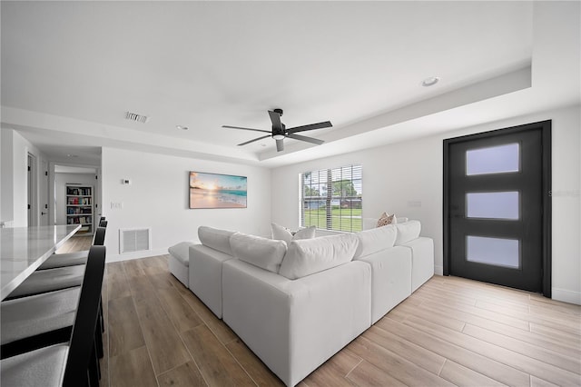 326 Randolph Rd, Venice, FL 34293 - living room featuring ceiling fan, light wood-style flooring, a raised ceiling, and recessed lighting