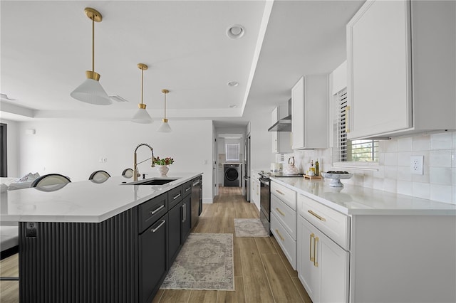 326 Randolph Rd, Venice, FL 34293 - kitchen featuring stainless steel electric stove, washer / dryer, light wood-type flooring, white cabinets, and dishwashing machine