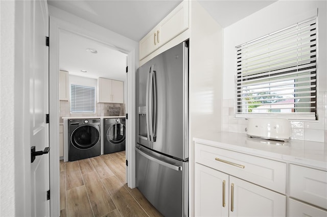 326 Randolph Rd, Venice, FL 34293 - laundry room featuring separate washer and dryer, cabinet space, and light wood-style floors