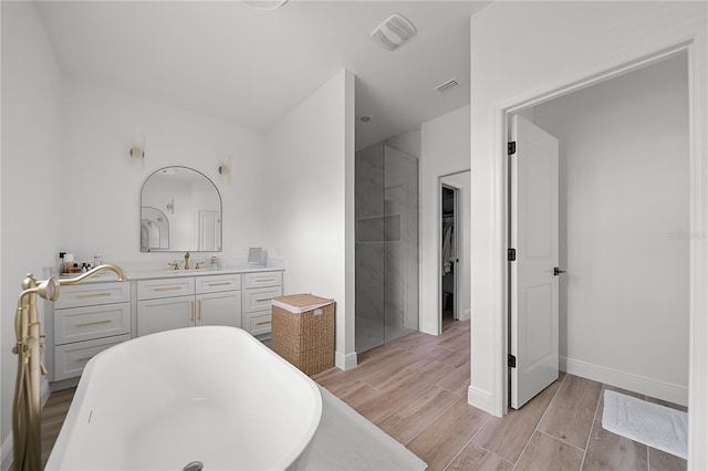 326 Randolph Rd, Venice, FL 34293 - bathroom featuring a freestanding bath, wood finished floors, vanity, and a spacious closet