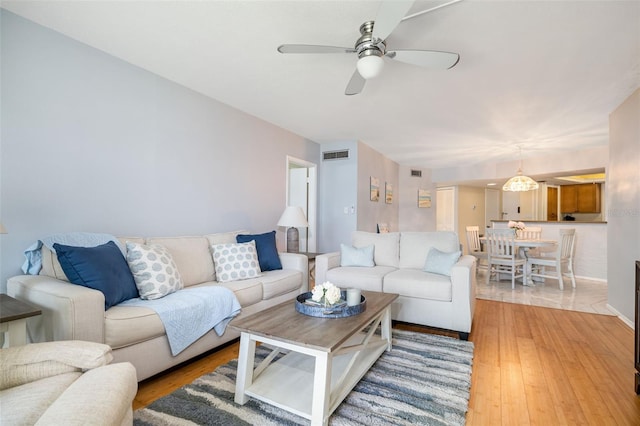 2110 Benjamin Franklin Dr Unit 301, Sarasota, FL 34236 - living room featuring ceiling fan and light wood finished floors