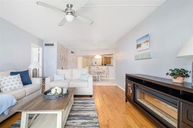2110 Benjamin Franklin Dr Unit 301, Sarasota, FL 34236 - living room with light wood-style floors and ceiling fan