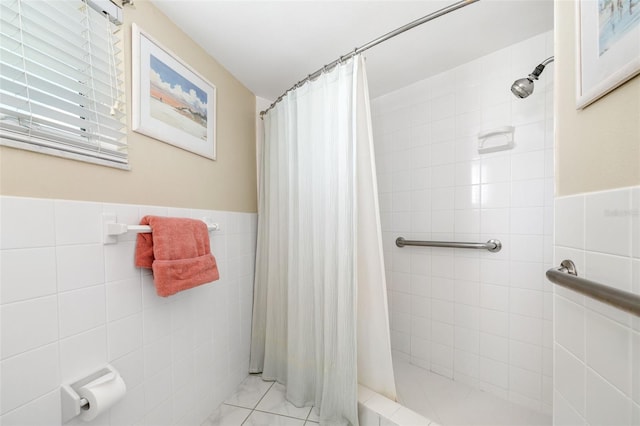 2110 Benjamin Franklin Dr Unit 301, Sarasota, FL 34236 - bathroom featuring tile walls, a tile shower, and wainscoting
