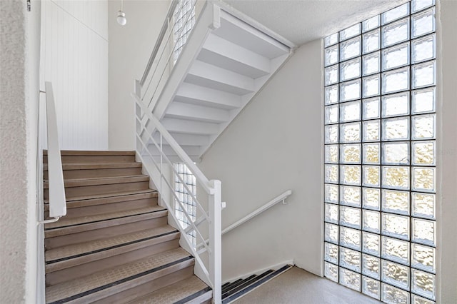 2110 Benjamin Franklin Dr Unit 301, Sarasota, FL 34236 - staircase with a textured ceiling