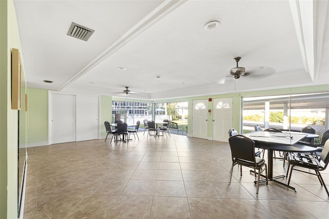 2110 Benjamin Franklin Dr Unit 301, Sarasota, FL 34236 - dining area featuring ceiling fan, light tile patterned floors, and a raised ceiling