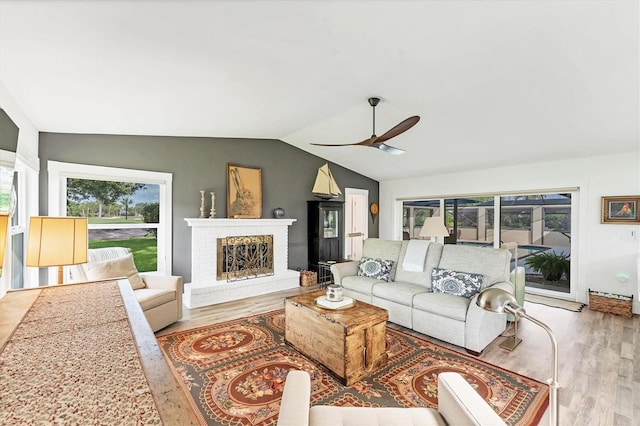 6105 45th St W, Bradenton, FL 34210 - living area with ceiling fan, vaulted ceiling, wood finished floors, and a fireplace