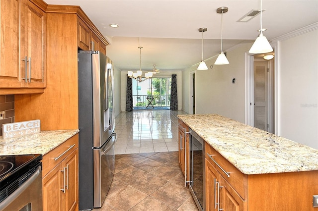 3985 Maceachen Blvd Unit 224, Sarasota, FL 34233 - kitchen with freestanding refrigerator, brown cabinets, wine cooler, a center island, and a chandelier