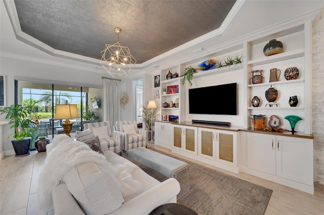 5469 Lampiasi St, Sarasota, FL 34238 - living room featuring a tray ceiling, a chandelier, ornamental molding, built in features, and light wood finished floors