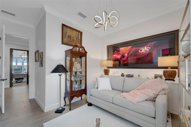 5469 Lampiasi St, Sarasota, FL 34238 - living room featuring a chandelier, ornamental molding, and wood finished floors