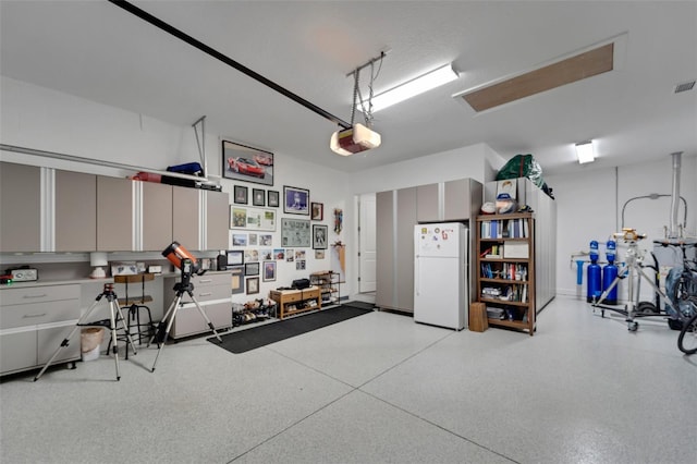 5469 Lampiasi St, Sarasota, FL 34238 - garage featuring freestanding refrigerator and a garage door opener