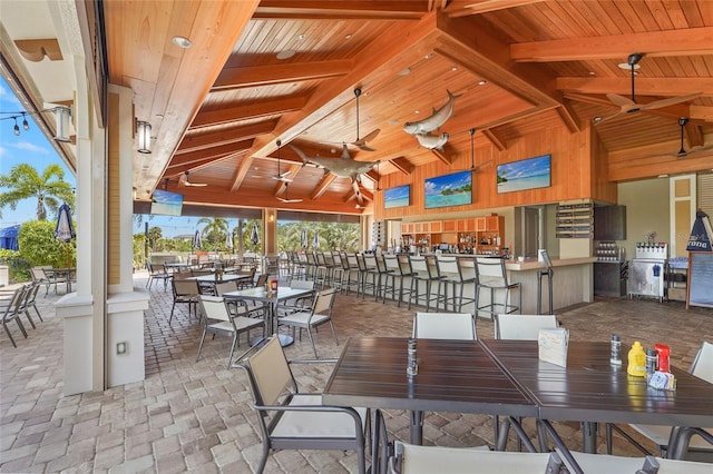 5469 Lampiasi St, Sarasota, FL 34238 - view of patio / terrace featuring ceiling fan, outdoor dining area, and exterior bar