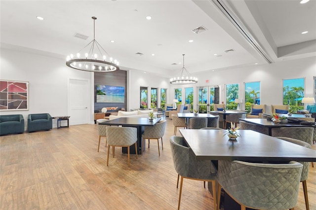 5469 Lampiasi St, Sarasota, FL 34238 - dining space with recessed lighting, light wood-style floors, and a chandelier