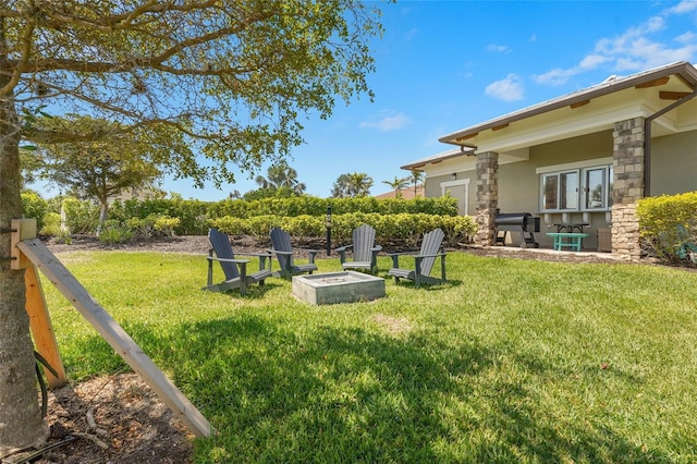 5469 Lampiasi St, Sarasota, FL 34238 - view of grassy yard with an outdoor fire pit