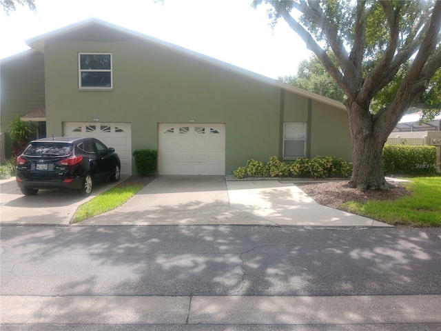 4154 Center Pointe Cir Unit 57A, Sarasota, FL 34233 - view of front of property featuring driveway, stucco siding, and an attached garage