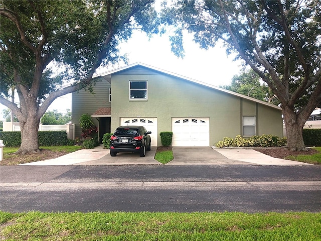 4154 Center Pointe Cir Unit 57A, Sarasota, FL 34233 - view of front of home with driveway, stucco siding, and a garage