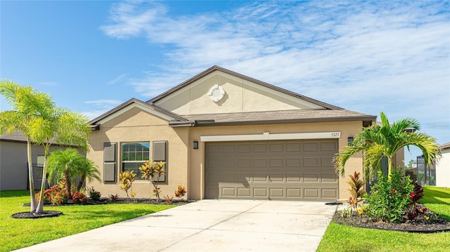 5327 Olano St, Palmetto, FL 34221 - ranch-style home with stucco siding, an attached garage, driveway, and a front yard